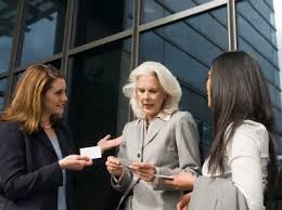 three woman exchanging business cards