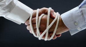 shaking hands tied with a rope