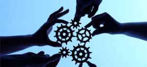 silhouette of hands holding gears