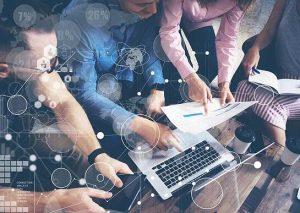 team working together with laptop and tablet