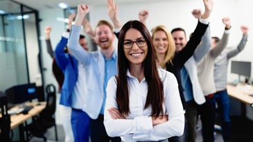 a woman standing in front of her supportive team