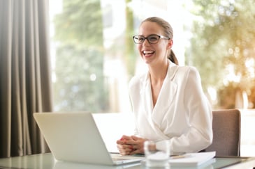 happy lady in front of her laptop