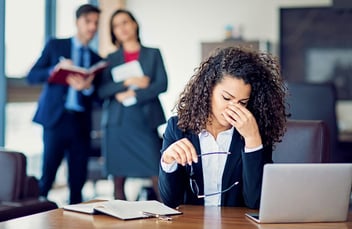 frustrated woman in a toxic work environment