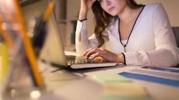 an unhappy woman in front of her laptop