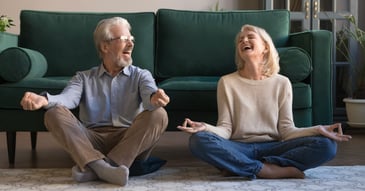 two middle aged people meditating
