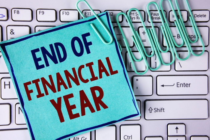 end of financial year post-it note on top of white keyboard