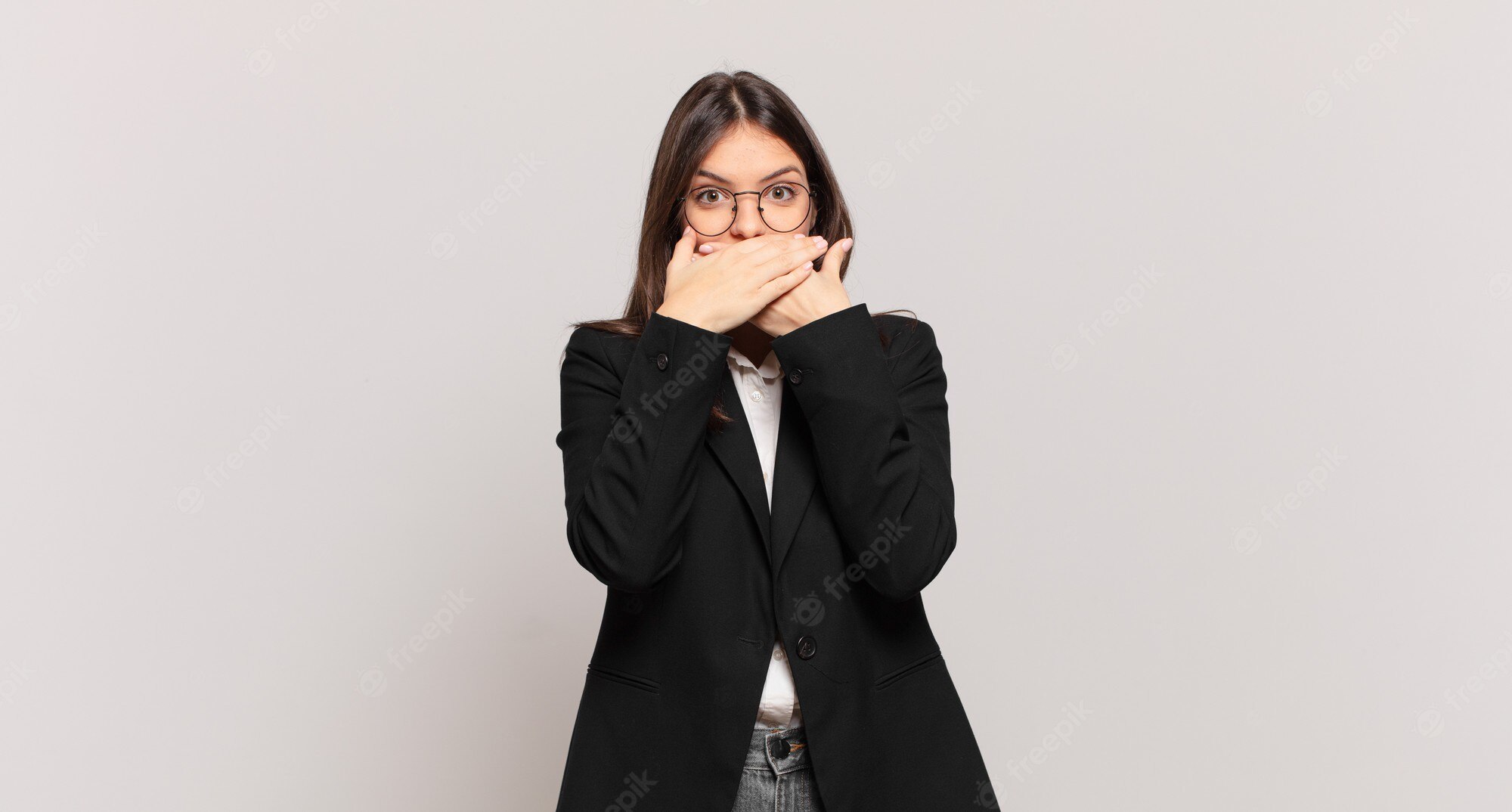 young-business-woman-covering-mouth-with-hands-with-shocked-surprised-expression
